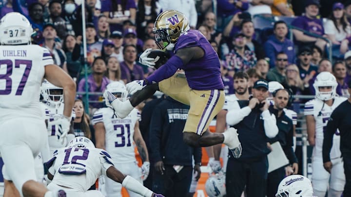 Jonah Coleman goes airborne to pick up a few extra yards against Northwestern. 