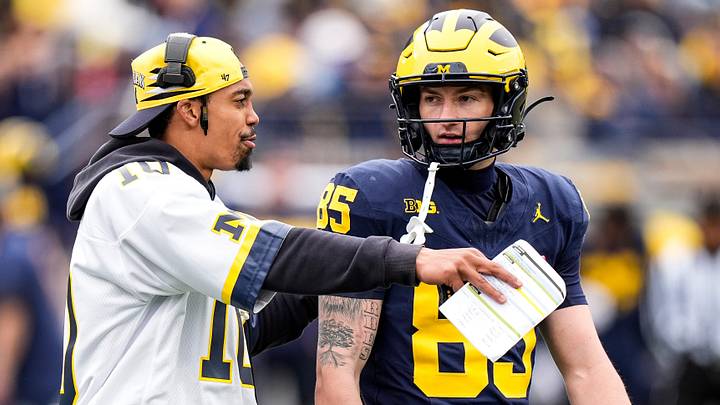Michigan wide receivers coach Micah Simon, left, talks to wide receiver Logan Forbes (85) during the spring game at Michigan Stadium in Ann Arbor on Saturday, April 18, 2026.