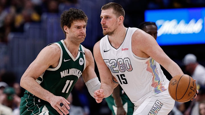 Mar 26, 2025; Denver, Colorado, USA; Denver Nuggets center Nikola Jokic (15) controls the ball as Milwaukee Bucks center Brook Lopez (11) guards in the fourth quarter at Ball Arena. Mandatory Credit: Isaiah J. Downing-Imagn Images Mar 26, 2025; Denver, Colorado, USA; Denver Nuggets center Nikola Jokic (15) controls the ball as Milwaukee Bucks center Brook Lopez (11) guards in the fourth quarter at Ball Arena. Mandatory Credit: Isaiah J. Downing-Imagn Images