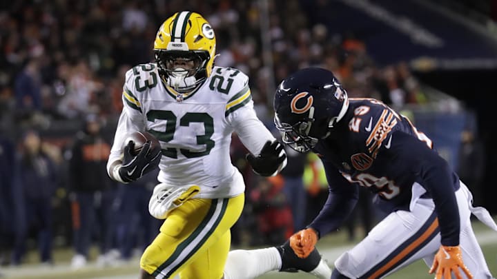 Dec 20, 2025; Chicago, Illinois, USA; Green Bay Packers running back Emanuel Wilson (23) runs for a gain against Chicago Bears cornerback Tyrique Stevenson (29) in the second quarter at Soldier Field. Mandatory Credit: Dan Powers-USA TODAY Network via Imagn Images