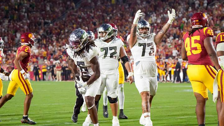 Oregon running back Dierre Hill Jr., left, celebrates a long run as the Oregon Ducks face the USC Trojans on Sept. 26, 2026, at Los Angeles Memorial Coliseum in Los Angeles, California.