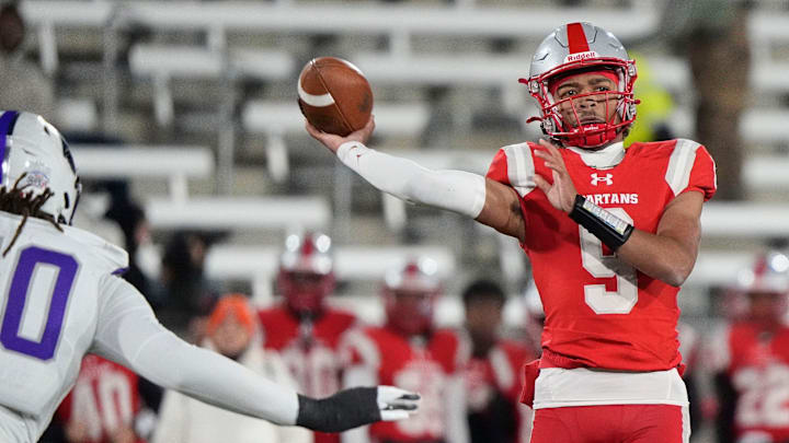 Dec 6, 2024; Birmingham, AL, USA; Saraland's KJ Lacey (9) thows a pass as he is pressured by a Parker defender at Protective Stadium in the 6A State Championship game. Parker defeated Saraland 28-17.