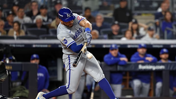 Oct 7, 2024; Bronx, New York, USA; Kansas City Royals outfielder Tommy Pham (22) hits a RBI single against the New York Yankees in the fourth inning during game two of the ALDS for the 2024 MLB Playoffs at Yankee Stadium. Mandatory Credit: Vincent Carchietta-Imagn Images