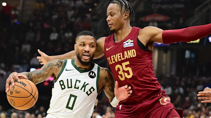 Nov 4, 2024; Cleveland, Ohio, USA; Milwaukee Bucks guard Damian Lillard (0) drives to the basket against Cleveland Cavaliers forward Isaac Okoro (35) during the first quarter at Rocket Mortgage FieldHouse. Mandatory Credit: Ken Blaze-Imagn Images Nov 4, 2024; Cleveland, Ohio, USA; Milwaukee Bucks guard Damian Lillard (0) drives to the basket against Cleveland Cavaliers forward Isaac Okoro (35) during the first quarter at Rocket Mortgage FieldHouse. Mandatory Credit: Ken Blaze-Imagn Images