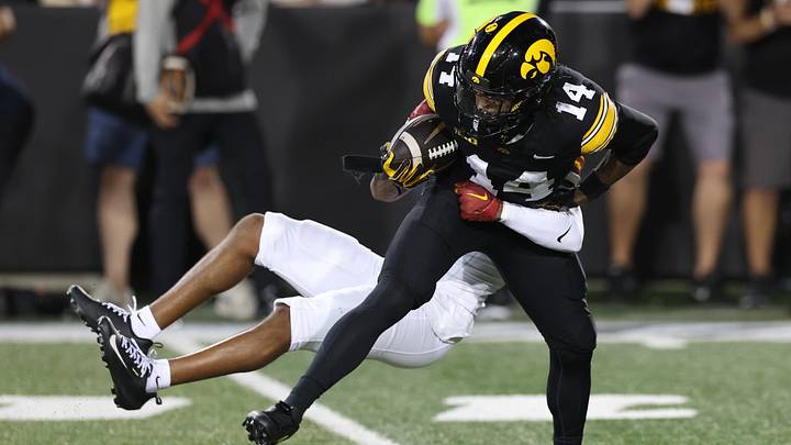 Sep 12, 2026; Iowa City, Iowa, USA;  Iowa Hawkeyes wide receiver Tony Diaz (14) is tackled by Iowa State Cyclones cornerback Seth Johnson (3) during the second quarter at Kinnick Stadium.  Mandatory Credit: Reese Strickland-Imagn Images