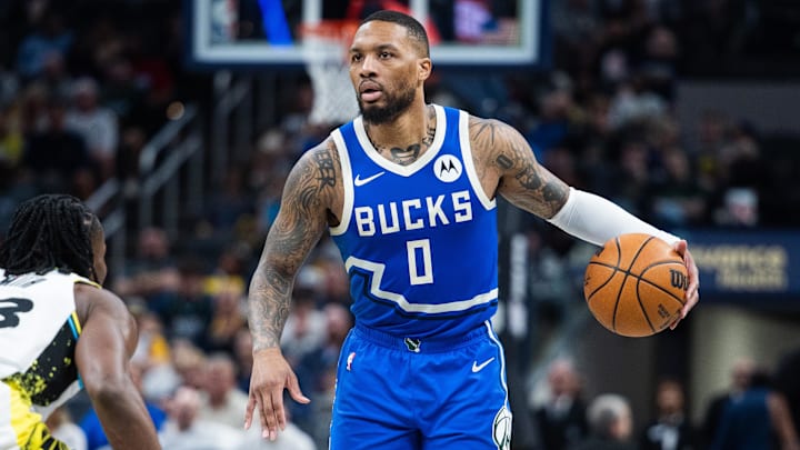 Mar 11, 2025; Indianapolis, Indiana, USA; Milwaukee Bucks guard Damian Lillard (0) dribbles the ball while Indiana Pacers forward Aaron Nesmith (23) defends in the second half  at Gainbridge Fieldhouse. Mandatory Credit: Trevor Ruszkowski-Imagn Images
