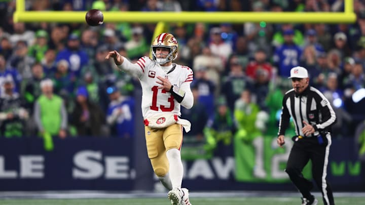 Jan 17, 2026; Seattle, WA, USA; San Francisco 49ers quarterback Brock Purdy (13) throws downfield against the Seattle Seahawks during the first half in an NFC Divisional Round game at Lumen Field. Mandatory Credit: Kevin Ng-Imagn Images