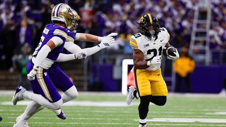 Oct 9, 2026; Seattle, Washington, USA; Iowa Hawkeyes running back L.J. Phillips Jr. (21) rushes against the Washington Huskies during the first quarter at Husky Stadium. Mandatory Credit: Joe Nicholson-Imagn Images