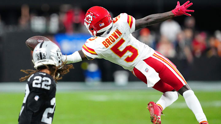Jan 4, 2026; Paradise, Nevada, USA; Kansas City Chiefs wide receiver Hollywood Brown (5) reaches for a pass in front of Las Vegas Raiders cornerback Eric Stokes (22) during the fourth quarter at Allegiant Stadium. Mandatory Credit: Stephen R. Sylvanie-Imagn Images