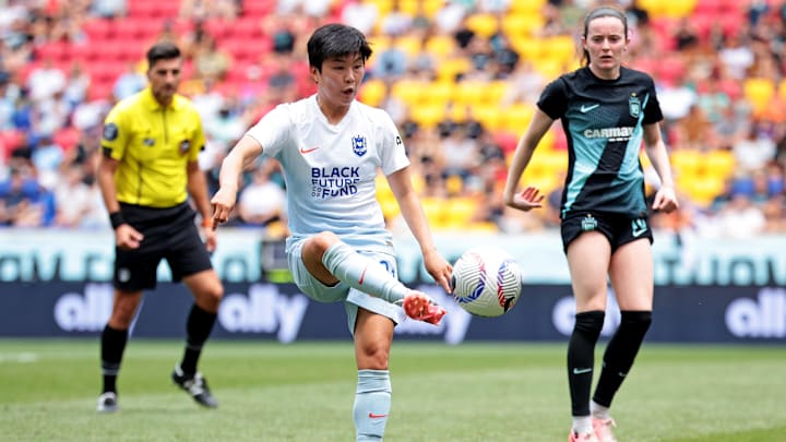 Jun 30, 2024; Harrison, New Jersey, USA; Seattle Reign FC midfielder Ji So-Yun (91) kicks the ball against NJ/NY Gotham FC midfielder Rose Lavelle (16) during the first half at Red Bull Arena. Mandatory Credit: Vincent Carchietta-USA TODAY Sports