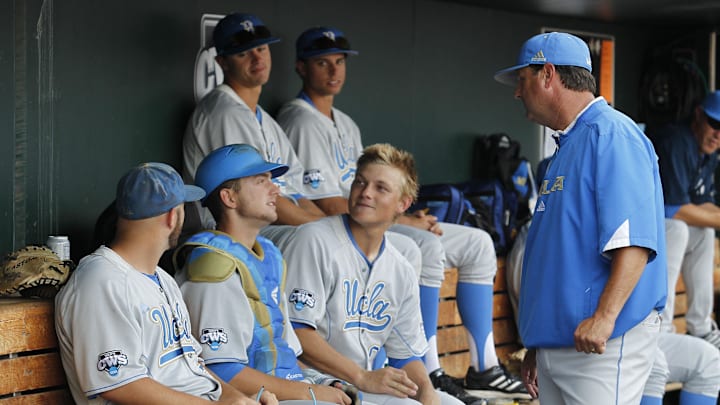 Jun 24, 2013; Omaha, NE, USA; UCLA Bruins head coach John Savage (22, standing) talks to his team in the dugout before game 1 of the College World Series finals against the Mississippi State Bulldogs at TD Ameritrade Park. Mandatory Credit: Bruce Thorson-Imagn Images Jun 24, 2013; Omaha, NE, USA; UCLA Bruins head coach John Savage (22, standing) talks to his team in the dugout before game 1 of the College World Series finals against the Mississippi State Bulldogs at TD Ameritrade Park. Mandatory Credit: Bruce Thorson-Imagn Images