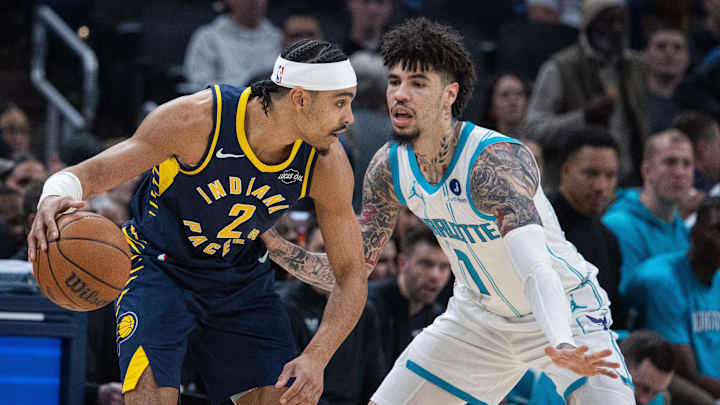 Nov 19, 2025; Indianapolis, Indiana, USA; Indiana Pacers guard Andrew Nembhard (2) dribbles the ball while Charlotte Hornets guard LaMelo Ball (1) defends in the first half at Gainbridge Fieldhouse. Mandatory Credit: Trevor Ruszkowski-Imagn Images