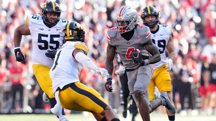 Oct 5, 2024; Columbus, OH, USA; Ohio State Buckeyes wide receiver Jeremiah Smith (4) runs toward Iowa Hawkeyes defensive back Xavier Nwankpa (1) during the first half of the NCAA football game at Ohio Stadium.