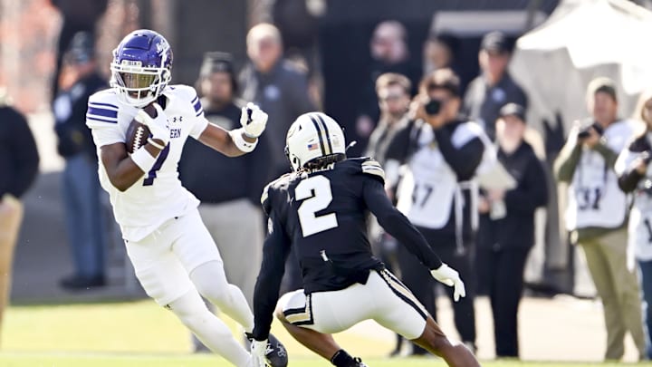 Nov 2, 2024; West Lafayette, Indiana, USA; Northwestern Wildcats wide receiver Calvin Johnson II (7) jukes to get around Purdue Boilermakers defensive back Nyland Green (2) during the first quarter at Ross-Ade Stadium. Mandatory Credit: Marc Lebryk-Imagn Images