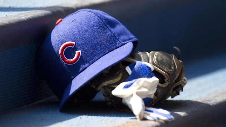 Apr 10, 2011; Milwaukee, WI, USA; Chicago Cubs hat and glove in the dugout prior to the game against the Milwaukee Brewers at Miller Park. The Brewers defeated the Cubs 6-5. Mandatory Credit: Jeff Hanisch-Imagn Images Apr 10, 2011; Milwaukee, WI, USA; Chicago Cubs hat and glove in the dugout prior to the game against the Milwaukee Brewers at Miller Park. The Brewers defeated the Cubs 6-5. Mandatory Credit: Jeff Hanisch-Imagn Images