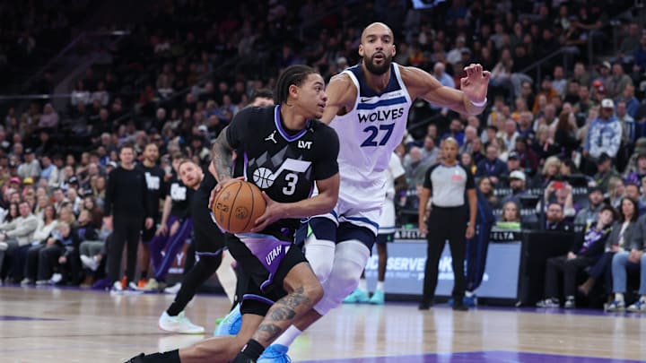 Jan 20, 2026; Salt Lake City, Utah, USA; Utah Jazz guard Keyonte George (3) goes to the basket against Minnesota Timberwolves center Rudy Gobert (27) during the first half at Delta Center. Mandatory Credit: Rob Gray-Imagn Images