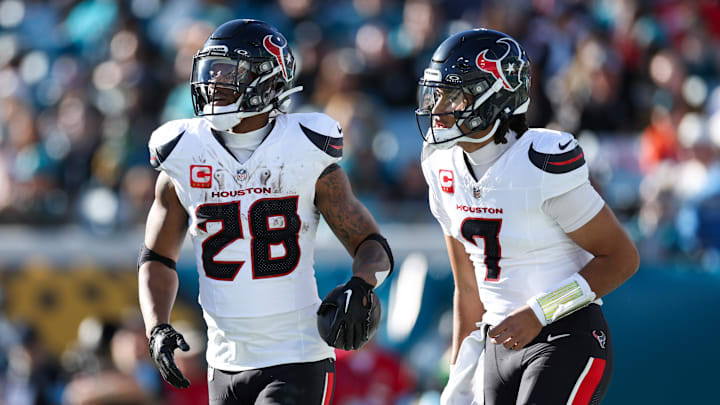 Dec 1, 2024; Jacksonville, Florida, USA; Houston Texans running back Joe Mixon (28) celebrates with quarterback C.J. Stroud (7) after scoring a touchdown  against the Jacksonville Jaguars in the third quarter at EverBank Stadium.
