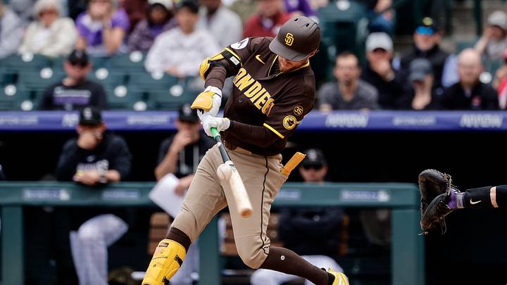 Apr 23, 2026; Denver, Colorado, USA; San Diego Padres second baseman Jake Cronenworth (9) hits a single in the fourth inning against the Colorado Rockies at Coors Field. Mandatory Credit: Isaiah J. Downing-Imagn Images