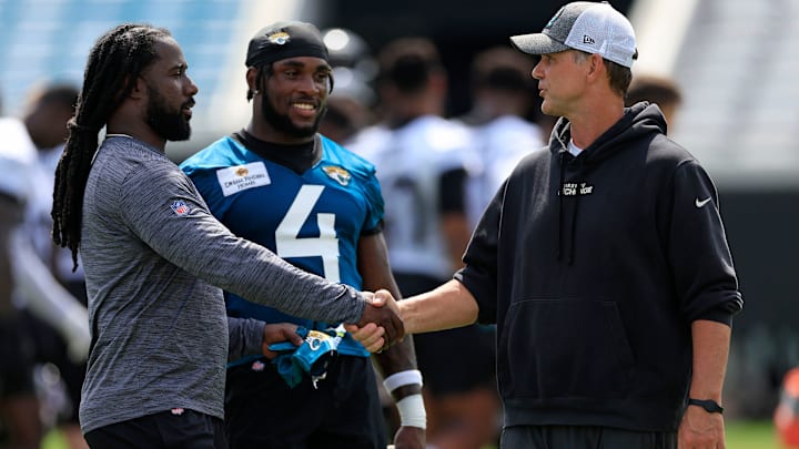 Jacksonville Jaguars general manager Trent Baalke, right, shakes hands with Rolesville High School (N.C.) head football coach Rainer Rackley as running back Tank Bigsby (4) looks on after the third and final day of a mandatory minicamp Monday, June 12, 2023 at TIAA Bank Field in Jacksonville, Fla. Rackley is part of the Bill Walsh Diversity Coaching Fellowship. [Corey Perrine/Florida Times-Union