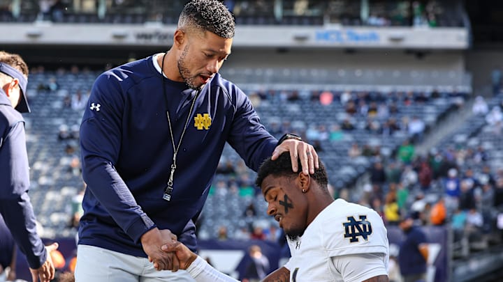 Oct 26, 2024; East Rutherford, New Jersey, USA; Notre Dame Fighting Irish head coach Marcus Freeman greets players before the game against the Navy Midshipmen at MetLife Stadium. Mandatory Credit: Vincent Carchietta-Imagn Images