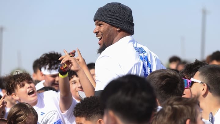 Eager campers surround Dallas Cowboys linebacker Micah Parsons at the Micah Parsons Lions Den Football Camp at St. John Paul II High School.