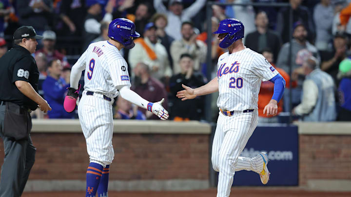 Oct 8, 2024; New York City, New York, USA; New York Mets first baseman Pete Alonso (20) celebrates scoring with outfielder Brandon Nimmo (9) on a two run single by outfielder Starling Marte (not pictured) in the sixth inning against the Philadelphia Phillies during game three of the NLDS for the 2024 MLB Playoffs at Citi Field. 