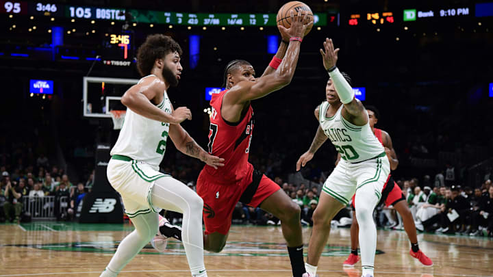 Oct 13, 2024; Boston, Massachusetts, USA;  Toronto Raptors guard Jahmi'us Ramsey (37) goes to the basket between Boston Celtics forward Anton Watson (28) and guard JD Davison (20) during the second half at TD Garden. Mandatory Credit: Bob DeChiara-Imagn Images
