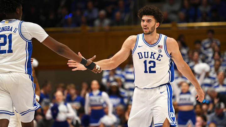 Feb 16, 2026; Durham, North Carolina, USA;  Duke Blue Devils forward Cameron Boozer (12) celebrates with Duke Blue Devils center Patrick Ngongba II (21) during the during the second half against the Syracuse Orange at Cameron Indoor Stadium. Mandatory Credit: Zachary Taft-Imagn Images