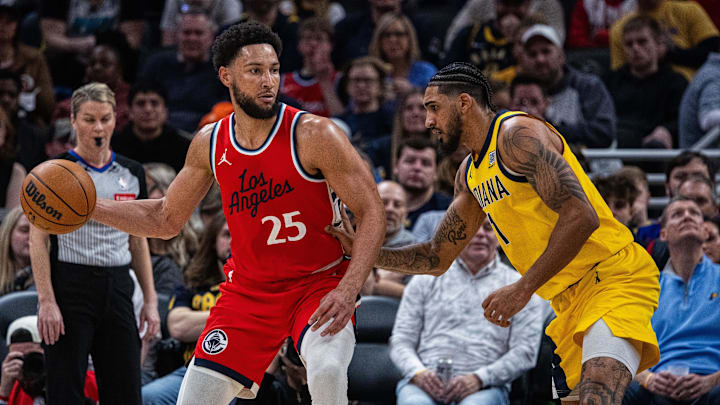 Feb 23, 2025; Indianapolis, Indiana, USA; LA Clippers guard Ben Simmons (25) dribbles the ball while Indiana Pacers forward Obi Toppin (1) defends in the second half at Gainbridge Fieldhouse. Mandatory Credit: Trevor Ruszkowski-Imagn Images
