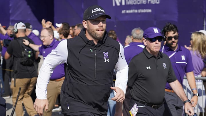 Oct 5, 2024; Evanston, Illinois, USA; Northwestern Wildcats head coach David Braun takes the field against the Indiana Hoosiers at Lanny and Sharon Martin Stadium. Mandatory Credit: David Banks-Imagn Images Oct 5, 2024; Evanston, Illinois, USA; Northwestern Wildcats head coach David Braun takes the field against the Indiana Hoosiers at Lanny and Sharon Martin Stadium. Mandatory Credit: David Banks-Imagn Images