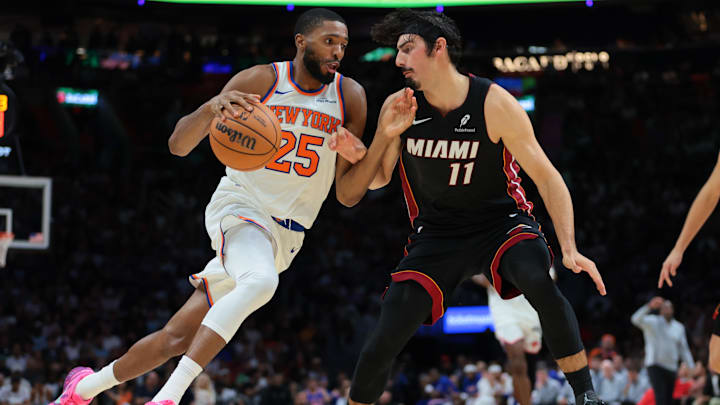 Oct 26, 2025; Miami, Florida, USA; New York Knicks guard Mikal Bridges (25) drives to the basket against Miami Heat forward Jaime Jaquez Jr. (11) during the fourth quarter at Kaseya Center. Mandatory Credit: Sam Navarro-Imagn Images
