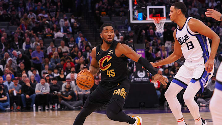 Mar 19, 2025; Sacramento, California, USA; Cleveland Cavaliers guard Donovan Mitchell (45) controls the ball against Sacramento Kings forward Keegan Murray (13) during the third quarter at Golden 1 Center. Mandatory Credit: Kelley L Cox-Imagn Images