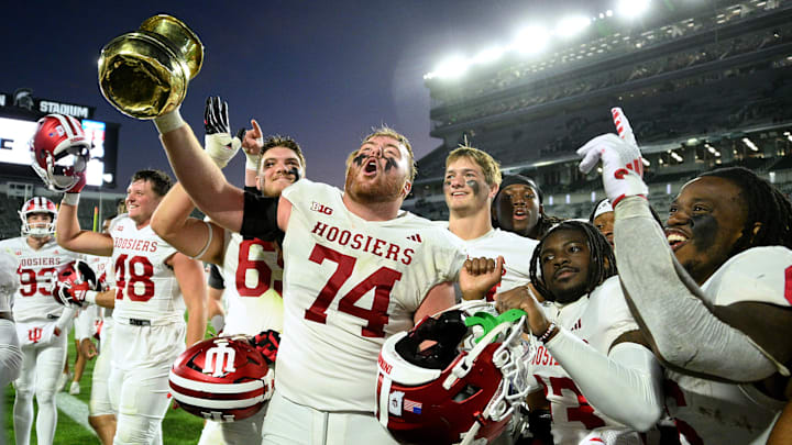 Indiana Hoosiers offensive lineman Bray Lynch holds up The Old Brass Spittoon after beating Michigan State Indiana Hoosiers offensive lineman Bray Lynch holds up The Old Brass Spittoon after beating Michigan State