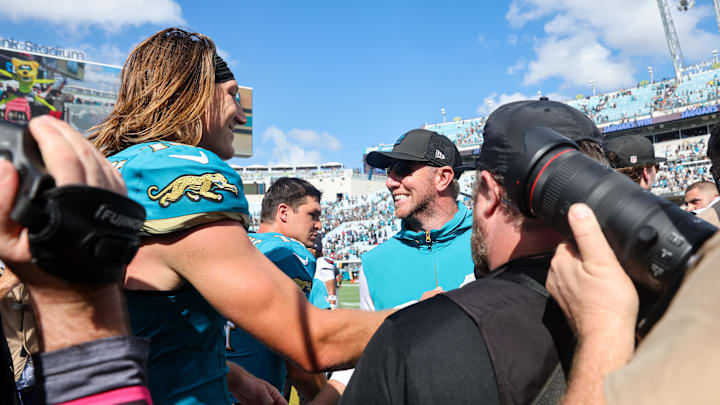 Sep 21, 2025; Jacksonville, Florida, USA; Jacksonville Jaguars head coach Liam Coen and quarterback Trevor Lawrence (16) shake hands after the game at EverBank Stadium. Mandatory Credit: Morgan Tencza-Imagn Images