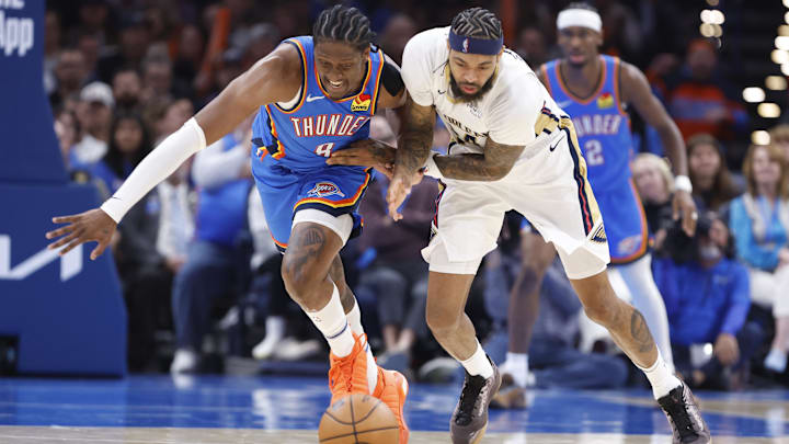 Nov 13, 2024; Oklahoma City, Oklahoma, USA; Oklahoma City Thunder forward Jalen Williams (8) and New Orleans Pelicans forward Brandon Ingram (14) fight for a loose ball during the second quarter at Paycom Center. Mandatory Credit: Alonzo Adams-Imagn Images
