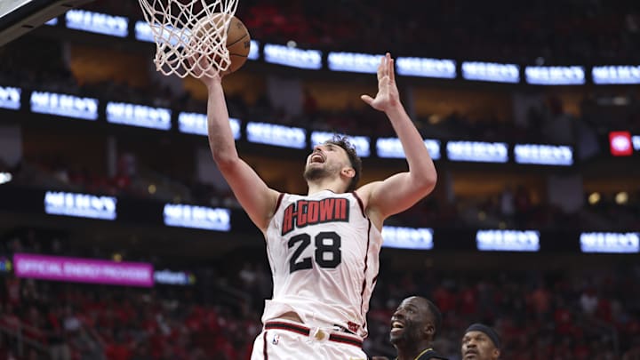 May 4, 2025; Houston, Texas, USA; Houston Rockets center Alperen Sengun (28) shoots the ball as Golden State Warriors forward Draymond Green (23) defends during game seven of the first round for the 2025 NBA Playoffs at Toyota Center. Mandatory Credit: Troy Taormina-Imagn Images