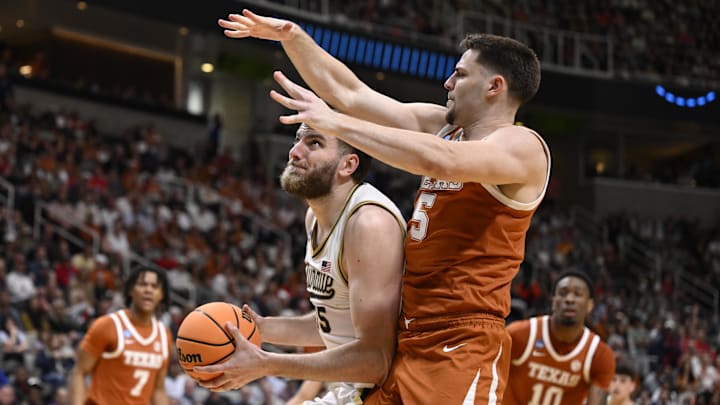 Mar 26, 2026; San Jose, CA, USA; Purdue Boilermakers center Oscar Cluff (45) goes to the basket against Texas Longhorns forward Camden Heide (5) in the Sweet Sixteen.