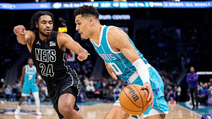 Mar 8, 2025; Charlotte, North Carolina, USA; Charlotte Hornets guard Josh Green (10) drives on Brooklyn Nets guard Cam Thomas (24) during the third quarter at Spectrum Center. Mandatory Credit: Scott Kinser-Imagn Images