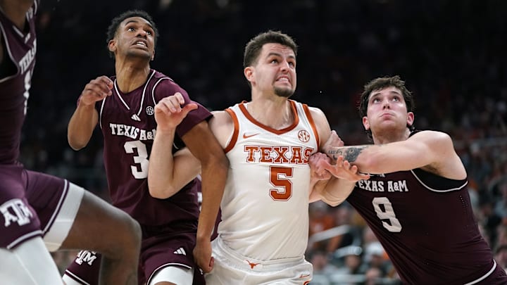Texas A&M Aggies guard Ryan Griffen and guard Ruben Dominguez block Texas Longhorns forward Camden Heide during the second half at Moody Center. 