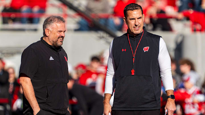 Nov 23, 2024; Lincoln, Nebraska, USA; Nebraska Cornhuskers head coach Matt Rhule and Wisconsin Badgers head coach Luke Fickell talk before a game at Memorial Stadium. Mandatory Credit: Dylan Widger-Imagn Images