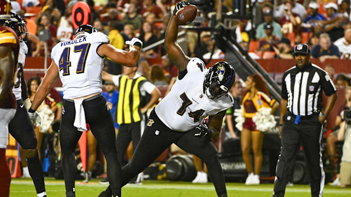 Baltimore Ravens OT David Sharpe spikes the ball after a touchdown by TE Travis Vokolek against the Washington Commanders.