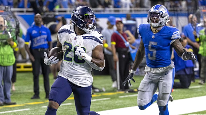 Oct 2, 2022; Detroit, Michigan, USA; Seattle Seahawks running back Rashaad Penny (20) runs with the ball for a touchdown in front of Detroit Lions safety DeShon Elliott (5) during the fourth quarter at Ford Field. Mandatory Credit: David Reginek-Imagn Images