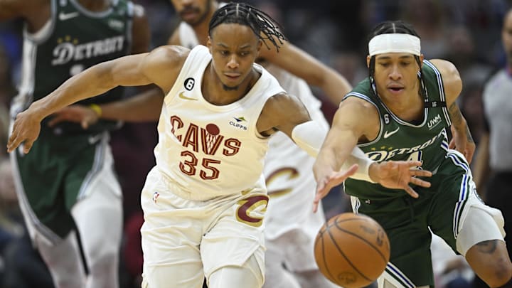 Mar 4, 2023; Cleveland, Ohio, USA; Cleveland Cavaliers forward Isaac Okoro (35) reaches for the ball beside Detroit Pistons guard R.J. Hampton (14) in the third quarter at Rocket Mortgage FieldHouse. Mandatory Credit: David Richard-Imagn Images