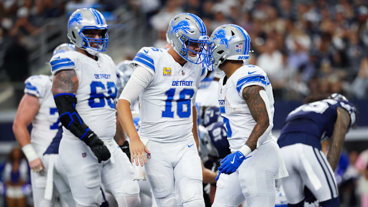 Detroit Lions running back David Montgomery (5) celebrates with Detroit Lions quarterback Jared Goff.
