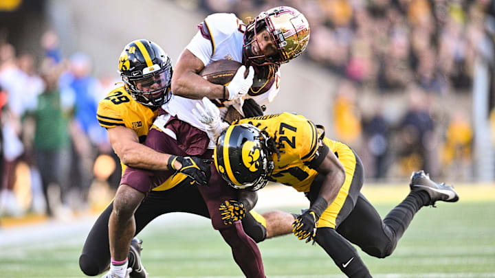 Oct 21, 2023; Iowa City, Iowa, USA; Minnesota Golden Gophers wide receiver Daniel Jackson (9) is tackled by Iowa Hawkeyes defensive back Jermari Harris (27) and defensive back Sebastian Castro (29) during the fourth quarter at Kinnick Stadium. Mandatory Credit: Jeffrey Becker-USA TODAY Sports