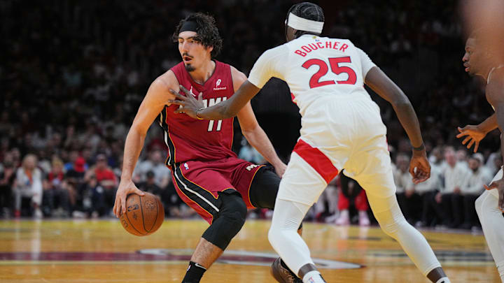 Nov 29, 2024; Miami, Florida, USA;  Miami Heat guard Jaime Jaquez Jr. (11) controls the ball against Toronto Raptors forward Chris Boucher (25) during the second half in an NBA Cup game at Kaseya Center. Mandatory Credit: Jim Rassol-Imagn Images