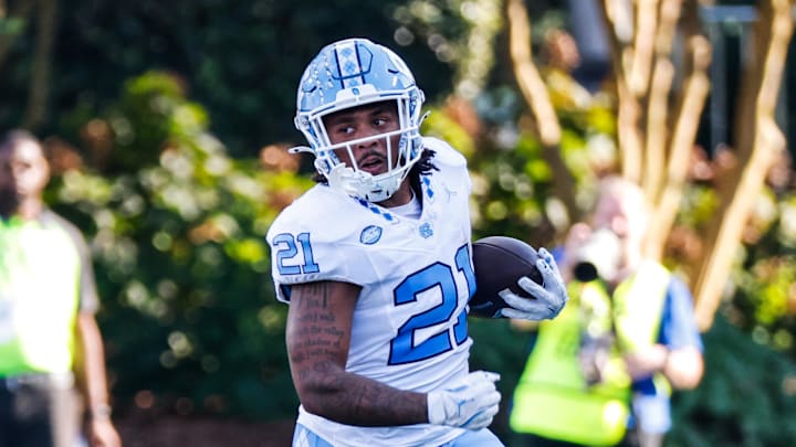 Sep 28, 2024; Durham, North Carolina, USA;  North Carolina Tar Heels running back Davion Gause (21) runs with the ball during the first half of the game against Duke Blue Devils at Wallace Wade Stadium. Mandatory Credit: Jaylynn Nash-Imagn Images