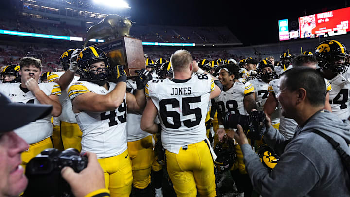 Oct 11, 2025; Madison, Wisconsin, USA; The Iowa Hawkeyes celebrate a win with The Heartland Trophy after the game against the Wisconsin Badgers at Camp Randall Stadium. Mandatory Credit: Ross Harried-Imagn Images