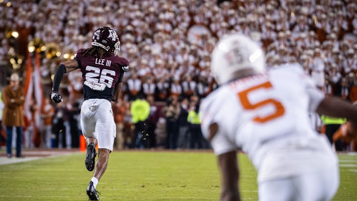 Nov 30, 2024; College Station, Texas, USA; Texas Longhorns wide receiver Ryan Wingo (5) watches as Texas A&M Aggies defensive back Will Lee III (26) runs the ball in to score a touchdown after an interception in the third quarter of the Lone Star Showdown at Kyle Field. Mandatory Credit: Sara Diggins/USA TODAY Network via Imagn Images
