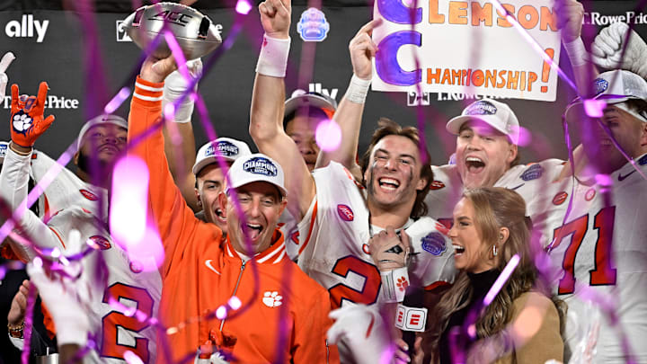 Dec 7, 2024; Charlotte, NC, USA; Clemson Tigers head coach Dabo Swinney, quarterback Cade Klubnik (2) and teammates celebrate after winning the 2024 ACC Championship game against the Southern Methodist Mustangs at Bank of America Stadium. Mandatory Credit: Bob Donnan-Imagn Images
